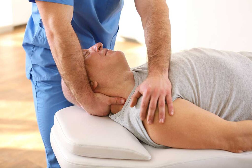 Adult seated in a car with one hand supporting a sore neck while reviewing accident symptoms.